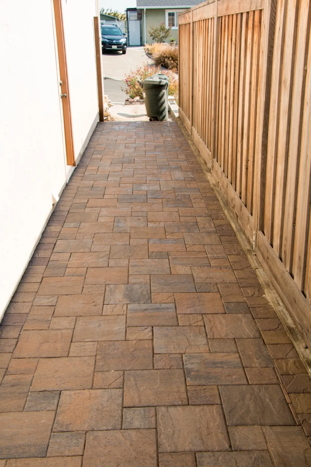 After — Bare dirt side yard → full-width paver walkway in Benicia