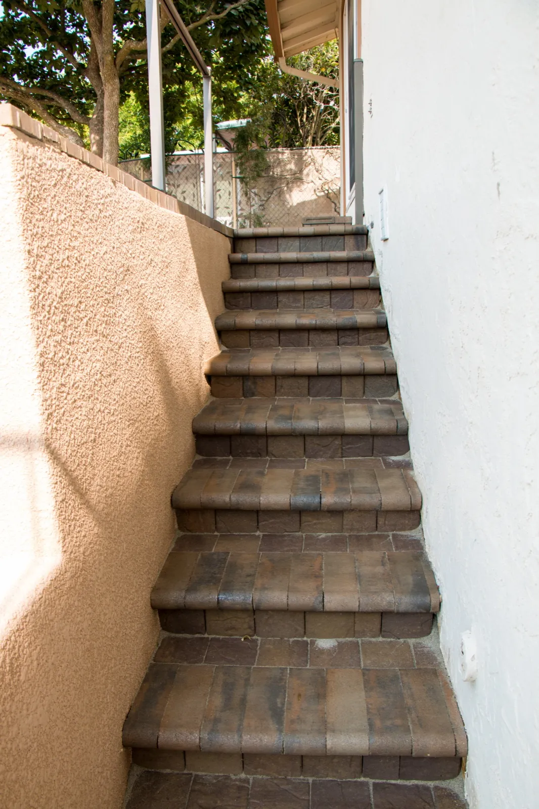 After — Crumbling block wall → paver staircase and stucco retaining wall in Benicia