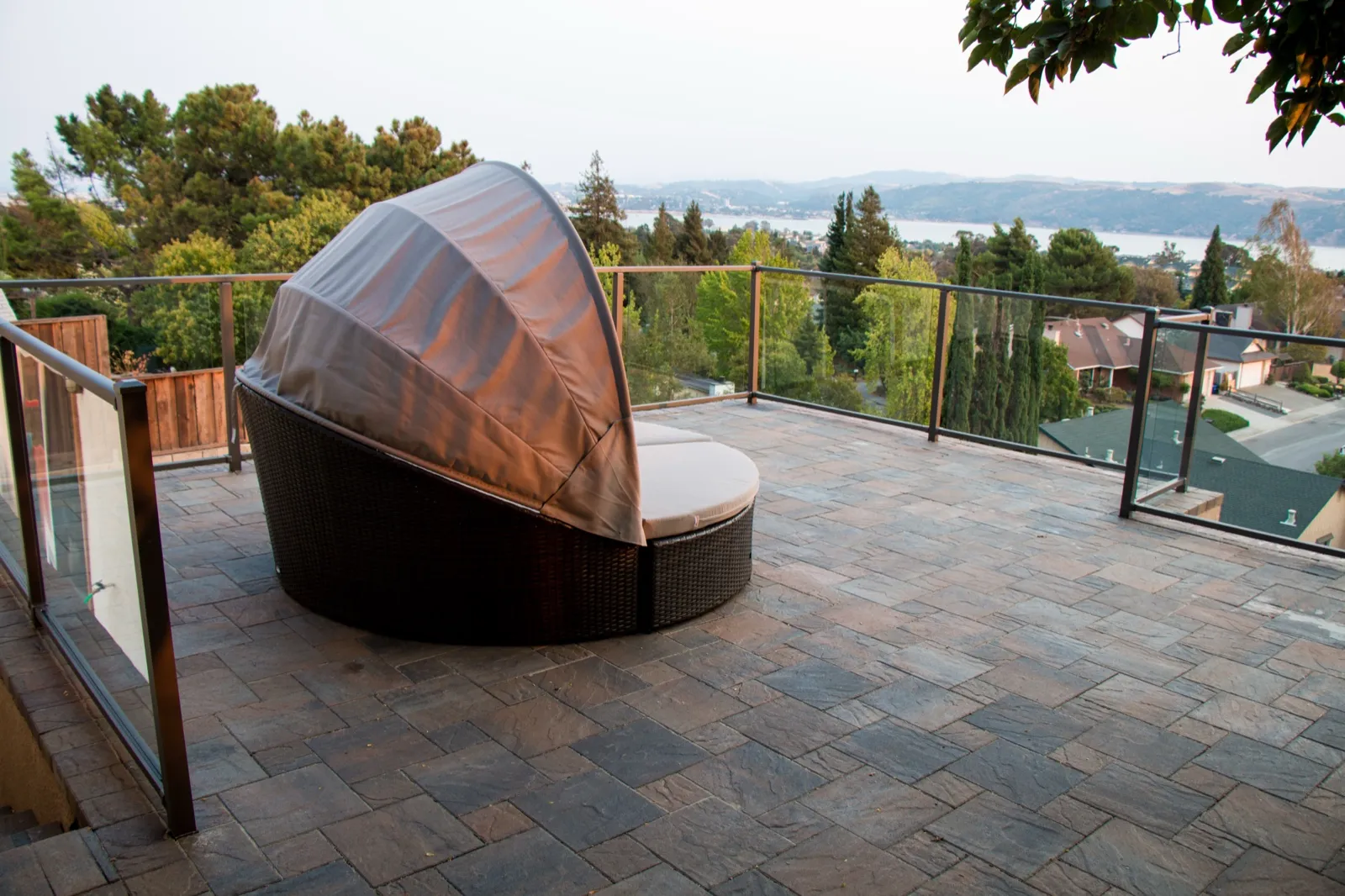 After — Graded gravel pad → paver terrace with glass rail and water views in Benicia