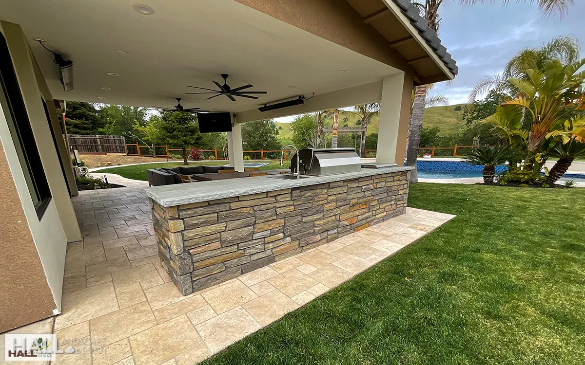 After — Blank patio slab → covered outdoor kitchen & bar in Fairfield