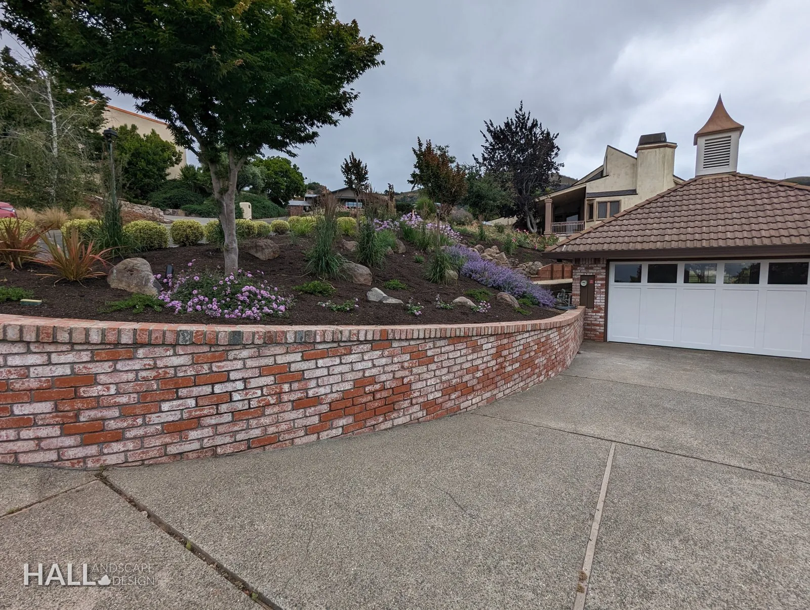 After — Tired brick planter & drive → rebuilt brick wall with boulders & lavender in Fairfield