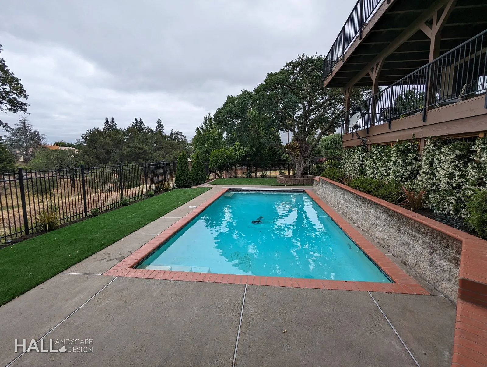 After — Green Valley pool: covered & cracked → resurfaced with new coping & lawn in Fairfield