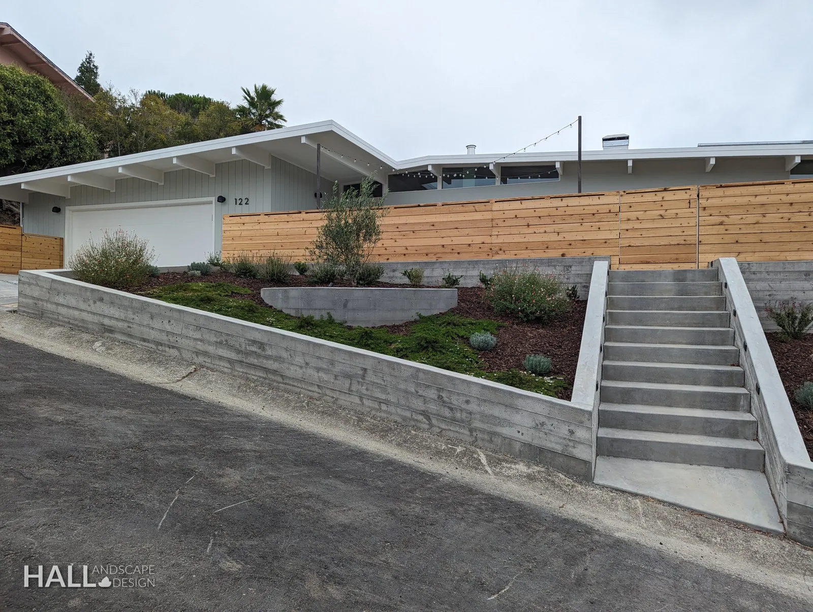 After — Shaded dirt slope → concrete steps, retaining walls & a planted terrace in Greenbrae