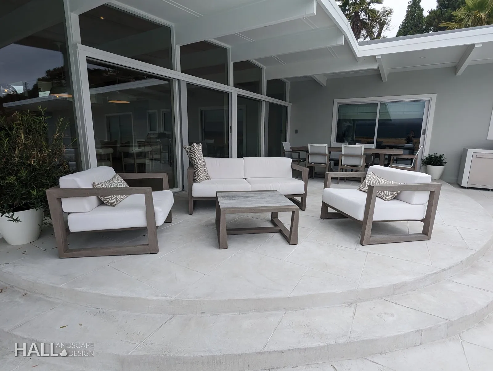 After — Construction-stage patio → poured terrace with a lounge set in Greenbrae