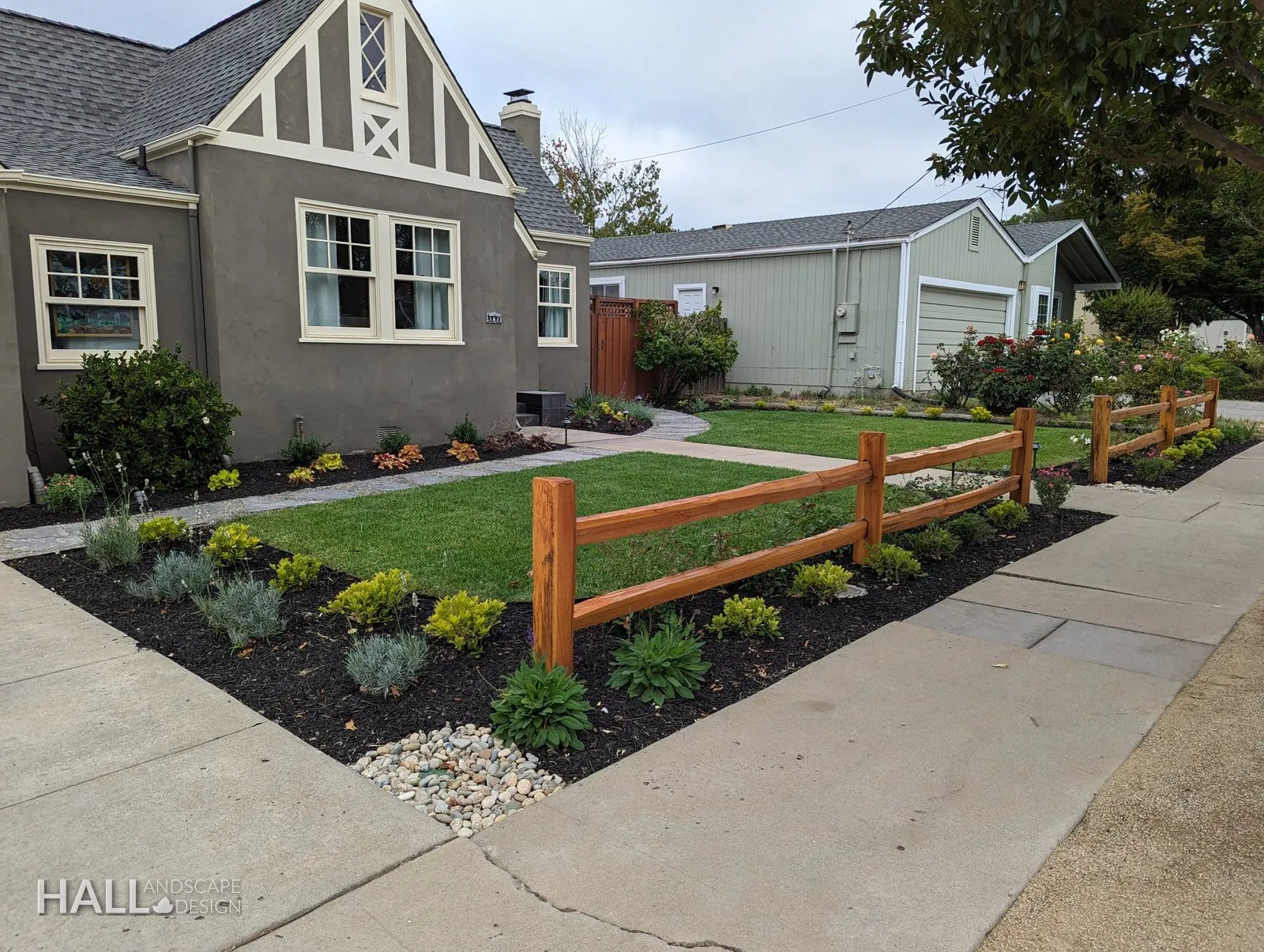 After — Corner lawn → cottage border with boulders & a split-rail edge in Healdsburg