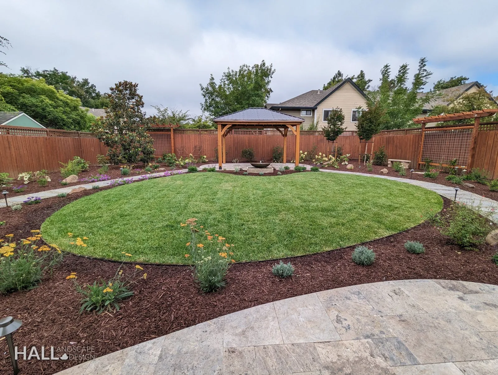 After — Dead lawn → circular lawn, mulched beds & a backyard pavilion in Healdsburg