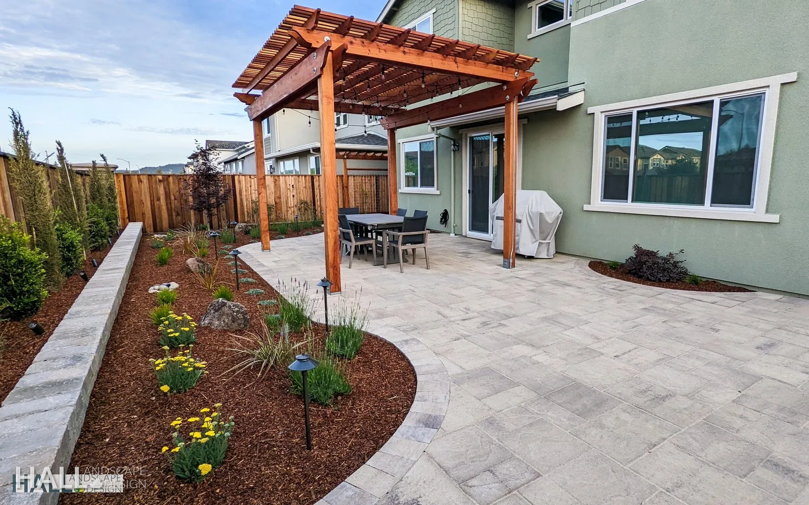 After — Blank dirt yard → pergola dining patio & planting in Napa