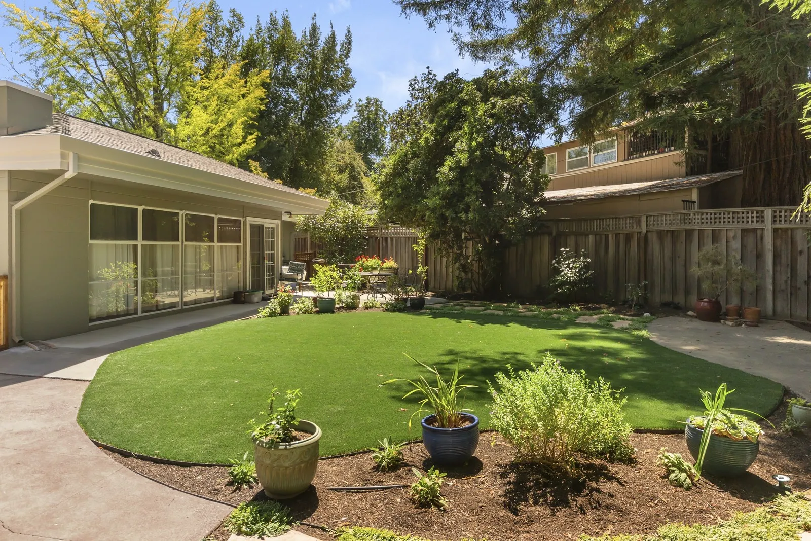 After — Backyard → curved lawn, patio & dining terrace in Napa