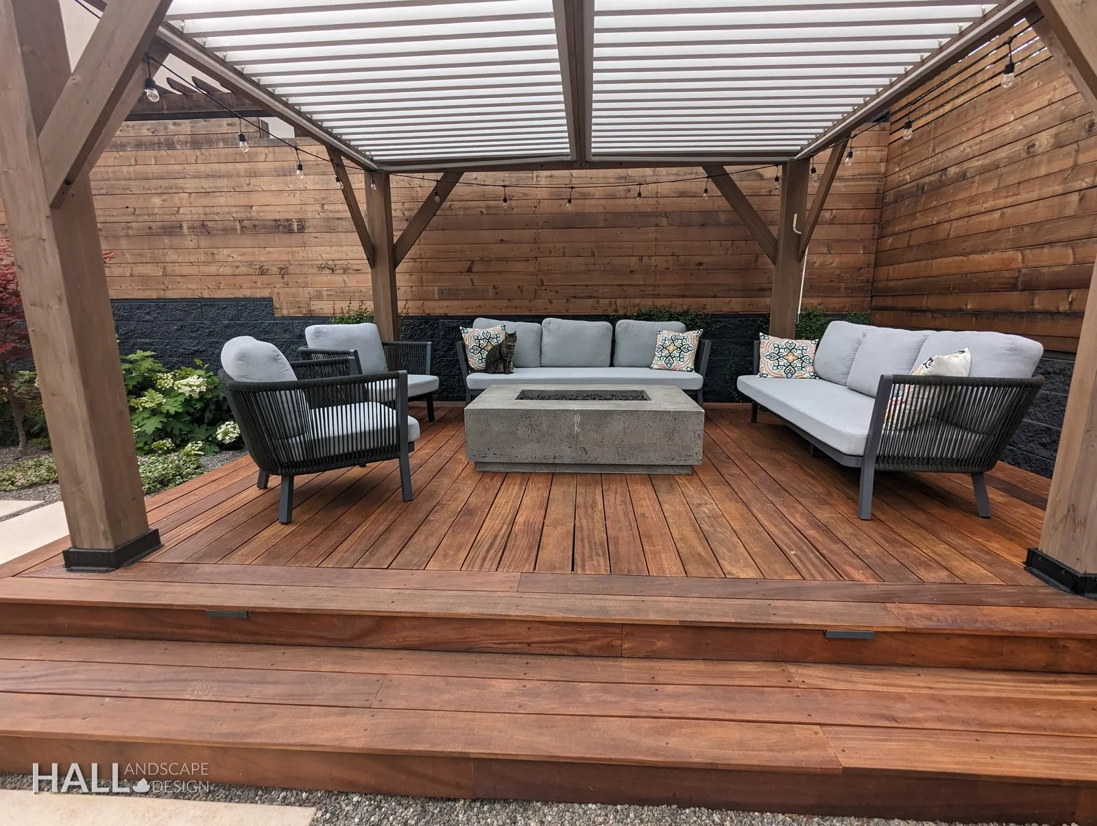 Evening pergola: Louvered roof, low seating, the fence as a wall. A finished Hall Landscape Design garden in Napa, California.