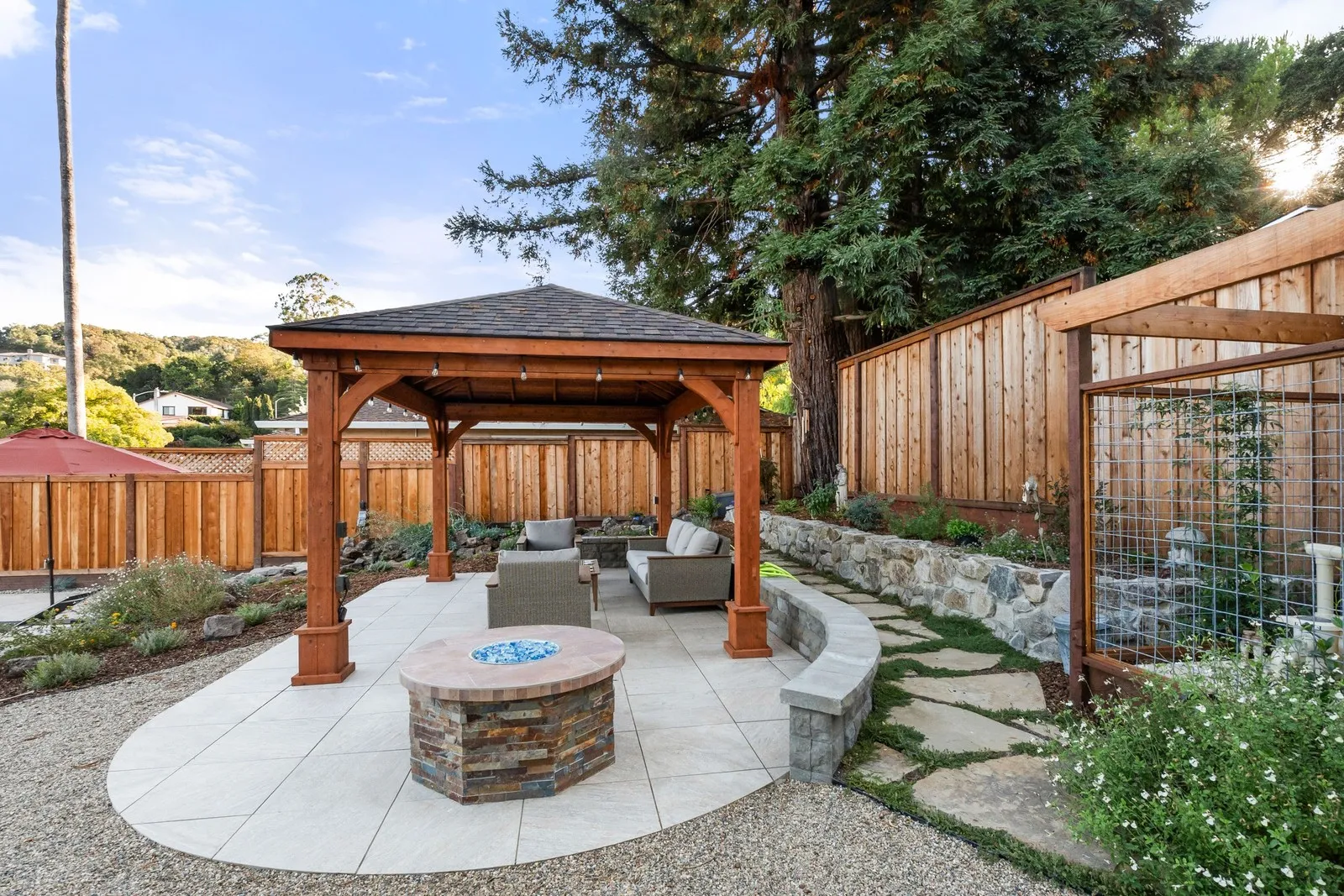 After — Overgrown yard → cedar pavilion & fire lounge in Novato