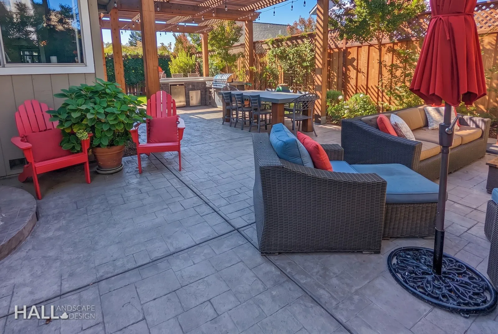 After — Worn deck & grill corner → stamped-concrete lounge under the pergola in Sonoma
