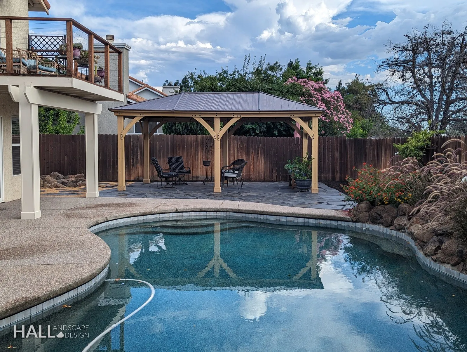 After — Old redwood deck → poolside cedar pavilion & boulder planting in Suisun City
