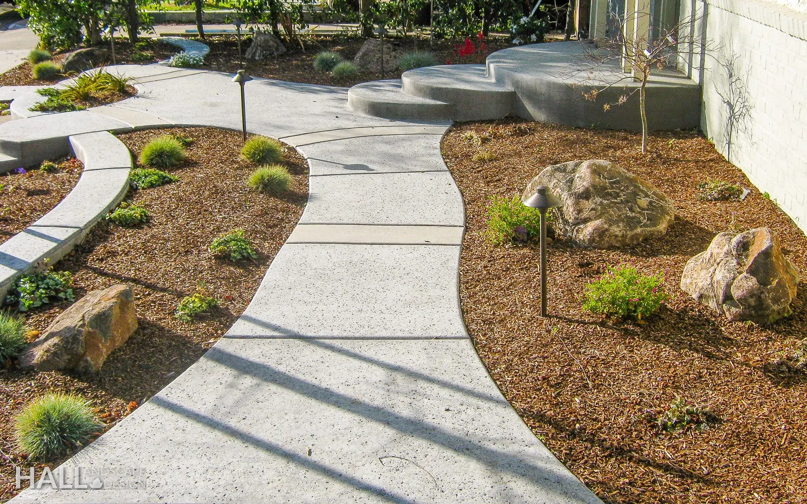 After — Thirsty lawn → winding path through boulder & gravel planting in Vacaville