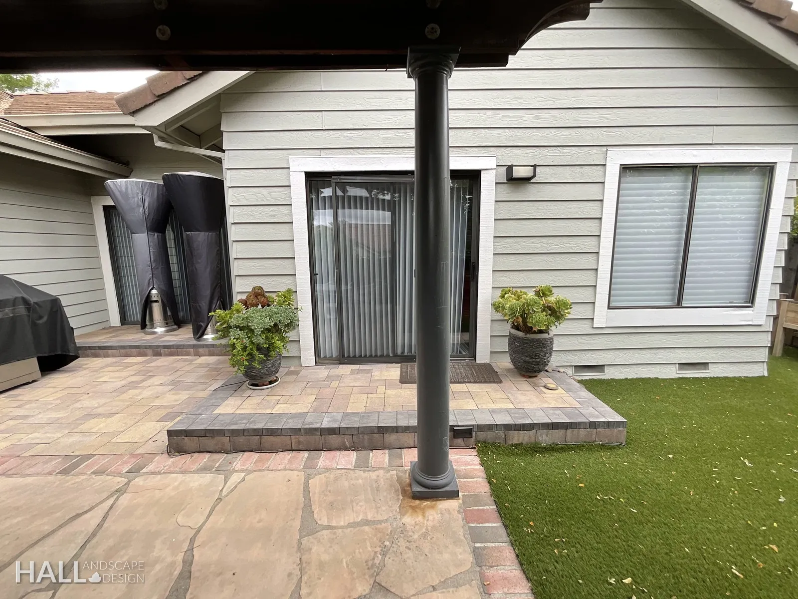After — Cluttered patio corner → clean paver terrace & turf edge in Yountville